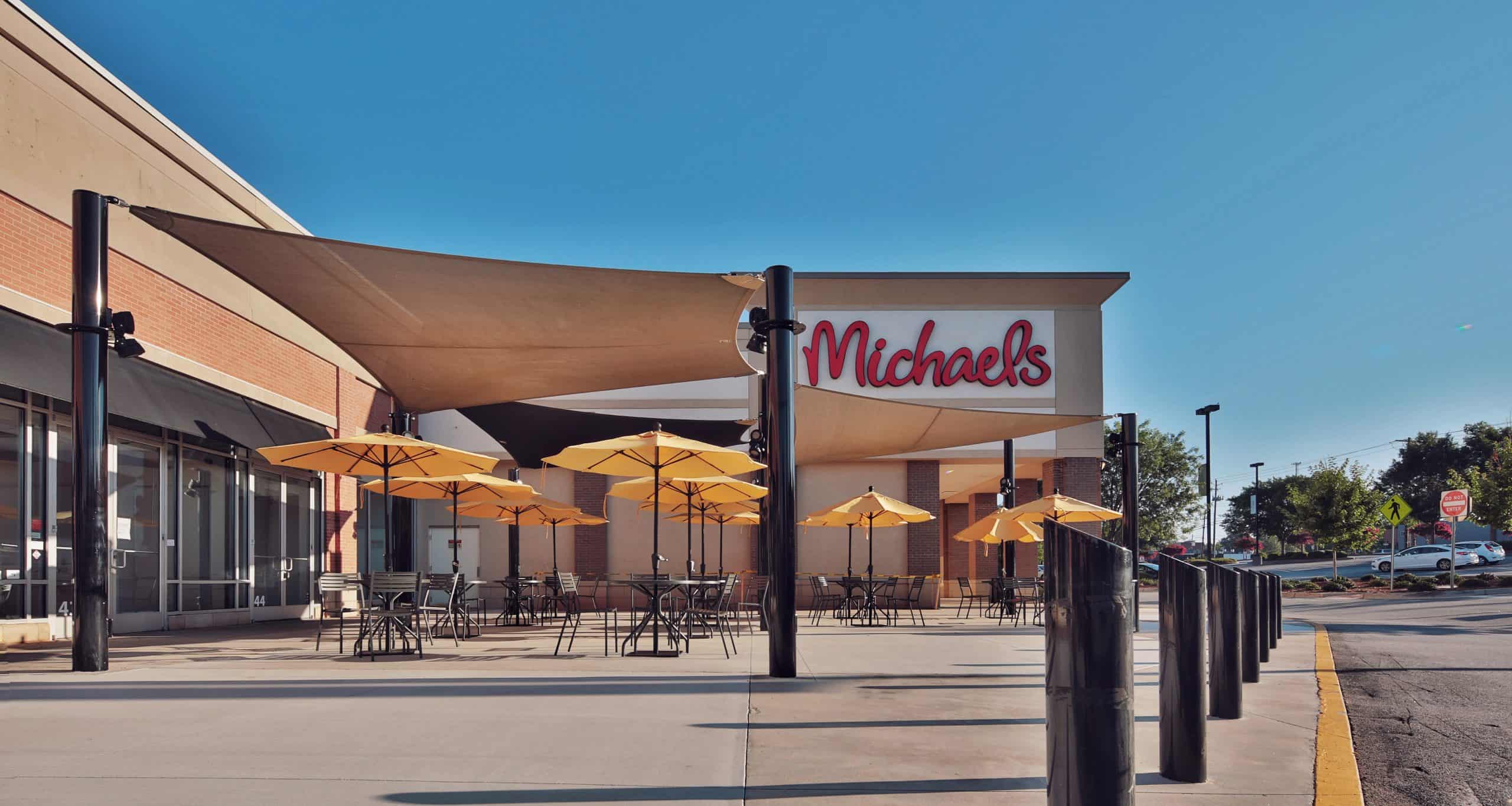 Shopping-center patio and shade sails in front of the Michaels facade in Athens, GA.