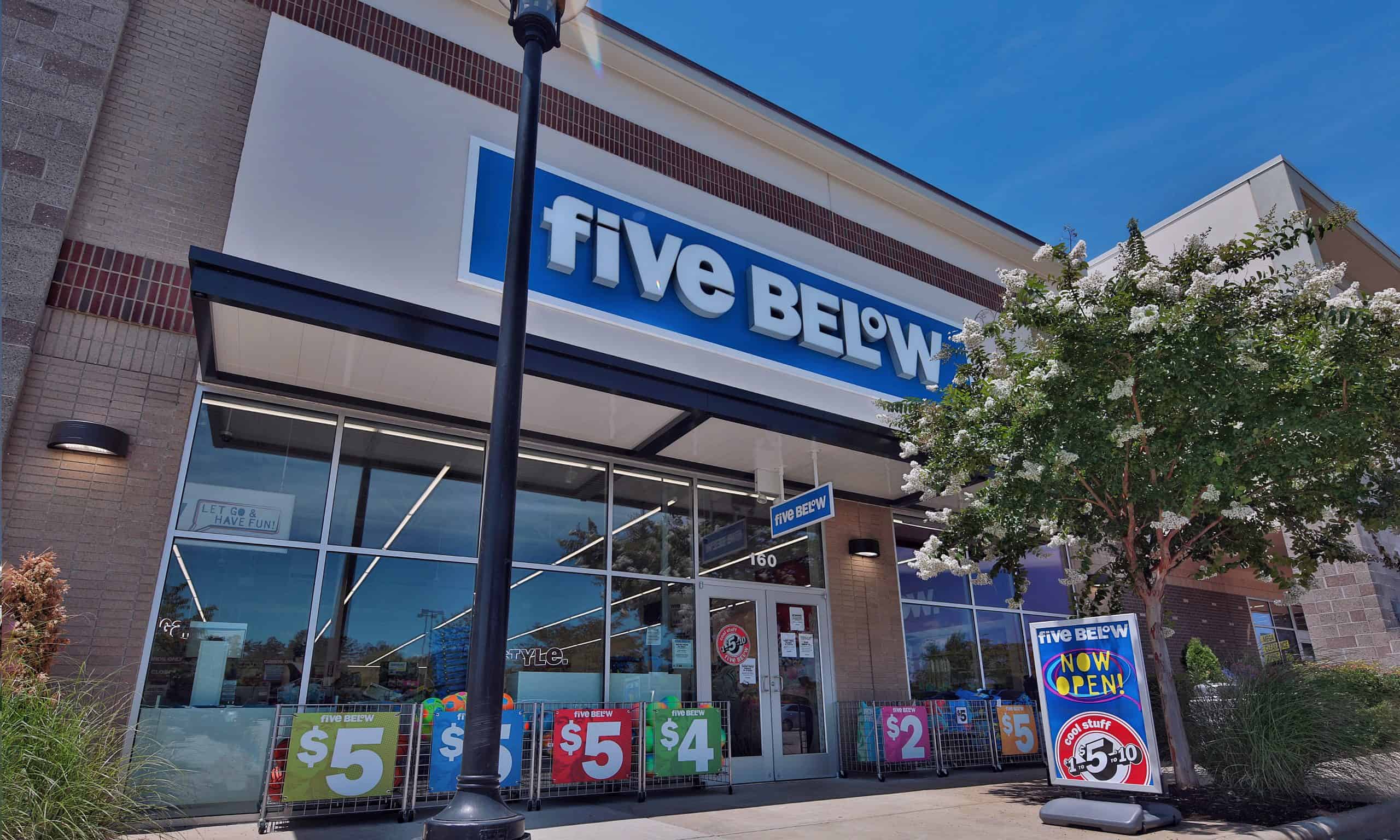 Close view of Five Below's glass storefront and blue sign in Holly Springs, NC.