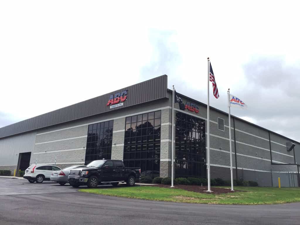 ABC Supply warehouse entrance and corner windows in Jacksonville, NC.