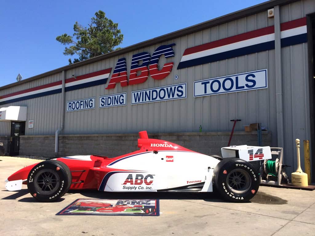 ABC Supply-branded race car beneath the warehouse sign in Myrtle Beach, SC.