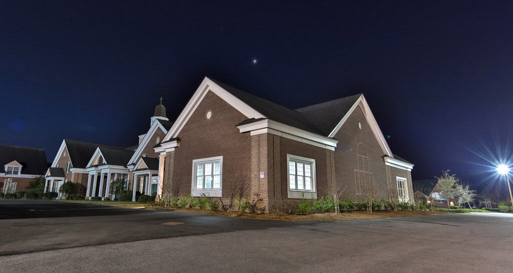 Gabled exterior of Surfside Presbyterian at night in Surfside Beach, SC.