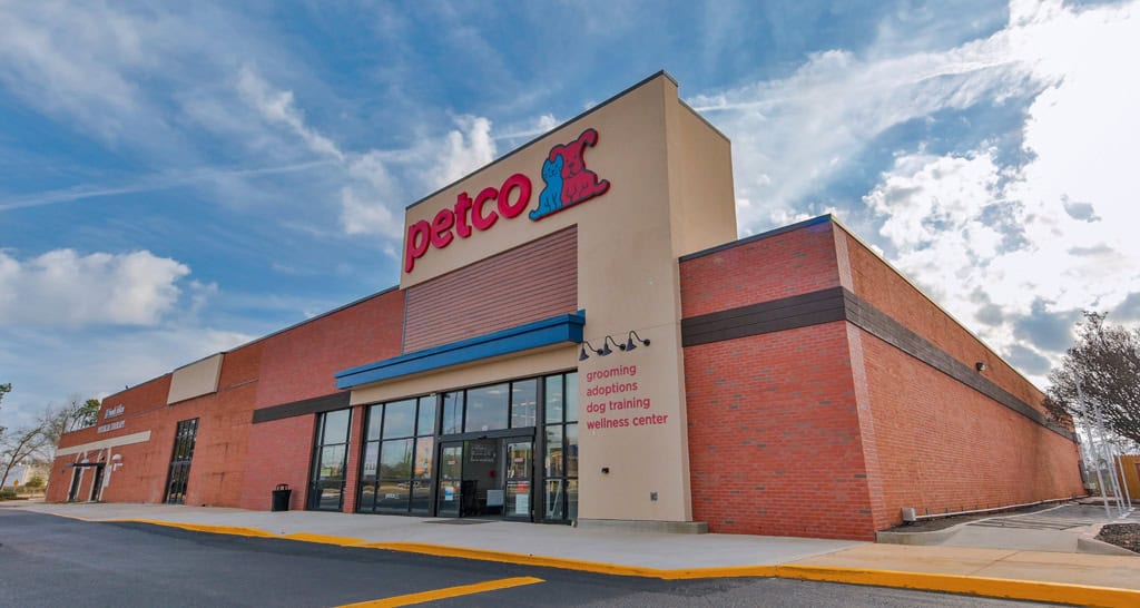 Petco storefront in Aiken with a brick facade, glass entrance and blue awning.