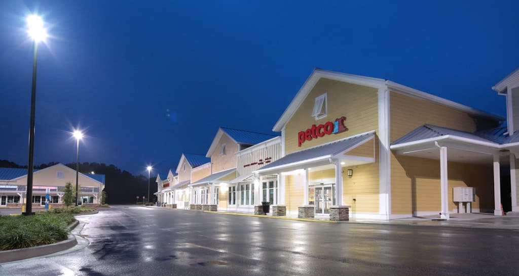 Petco in Pawleys Island at dusk, with yellow siding and a covered storefront walkway.