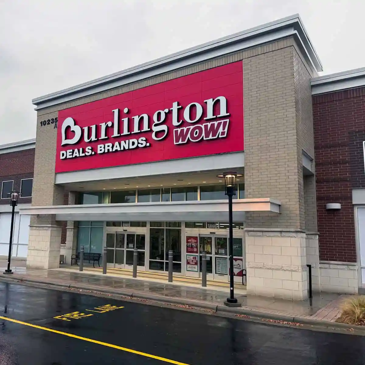 Angled view of Burlington's Charlotte entrance, with red signage and a canopy over the glass doors.