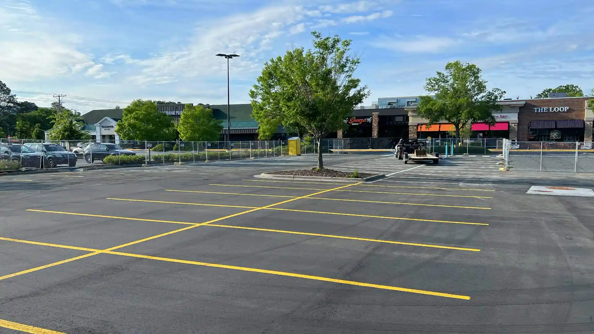 Striped parking spaces and storefronts at Eastgate Shopping Center.