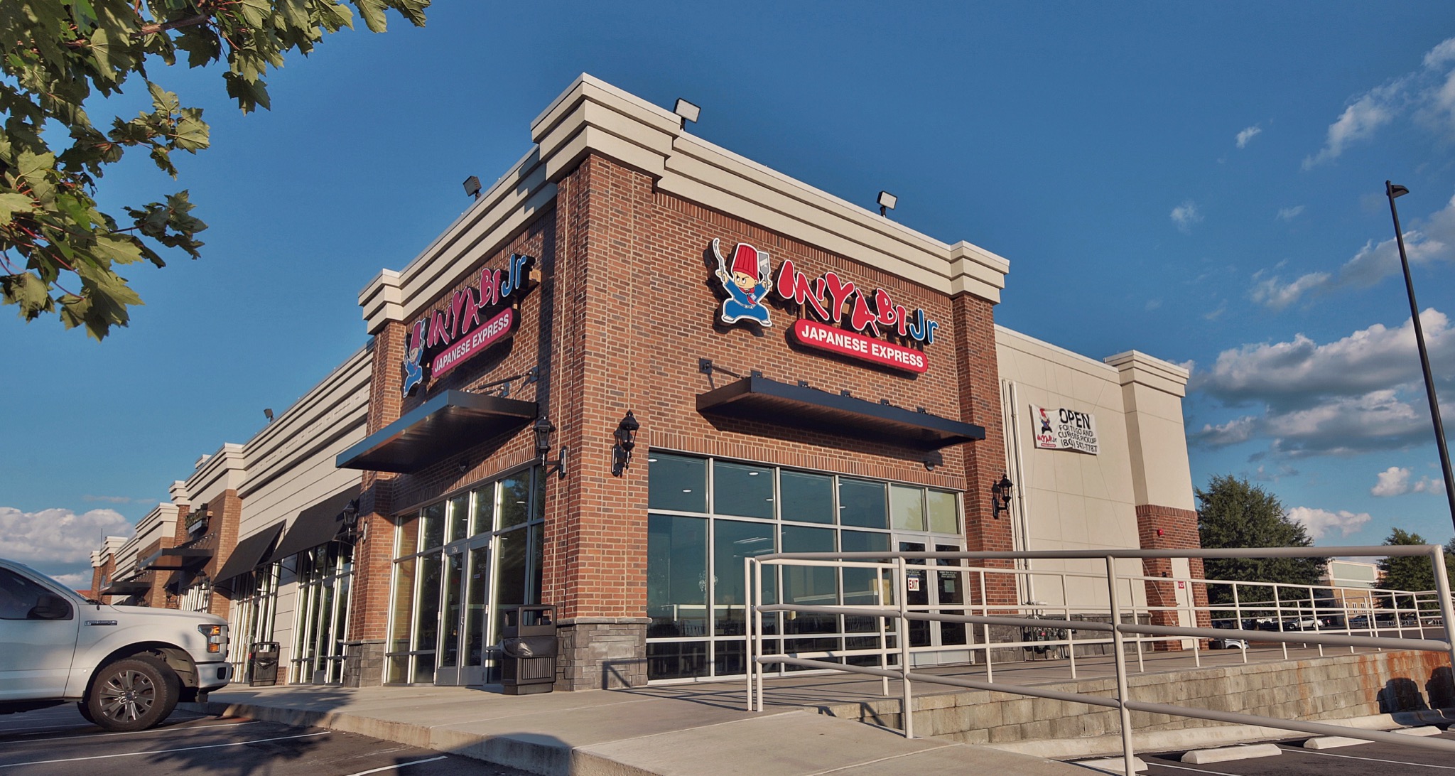 Miyabi Jr. storefront in Tega Cay with brick corner walls and a railed entrance ramp.