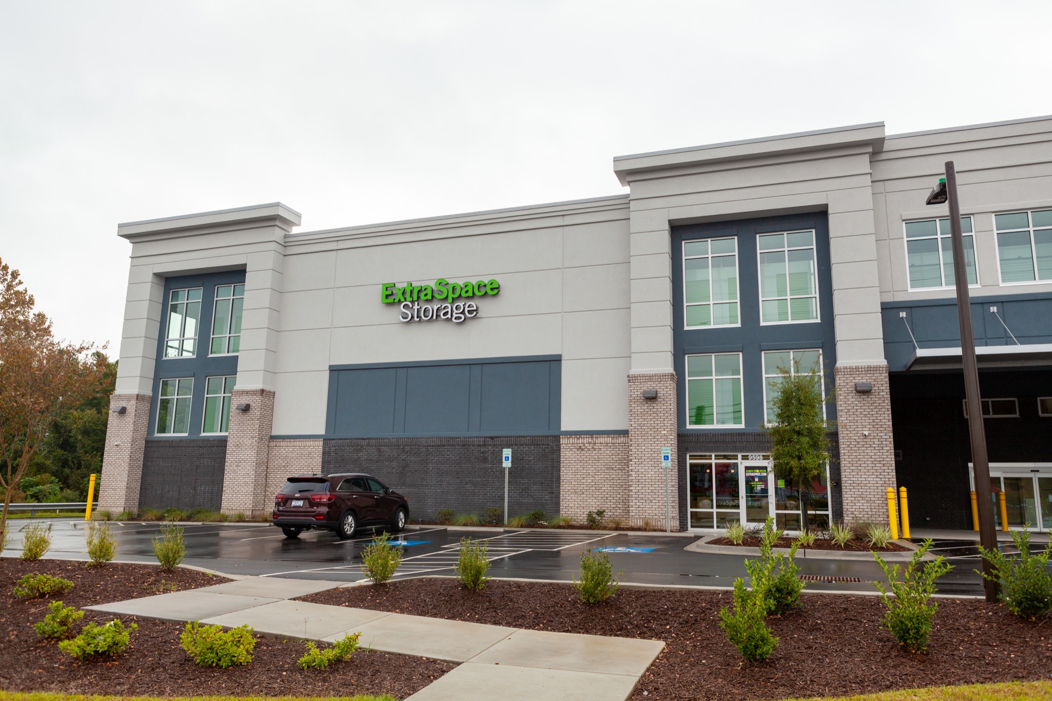 Extra Space Storage in North Myrtle Beach with its entrance, front landscaping and parking spaces.