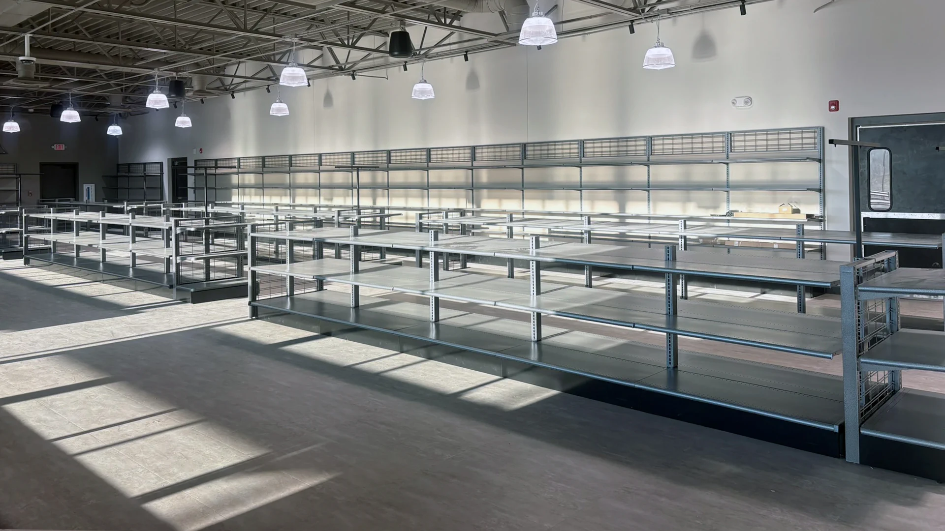 Retail display shelving beneath exposed ceiling trusses at the ABC store in Greensboro, NC.