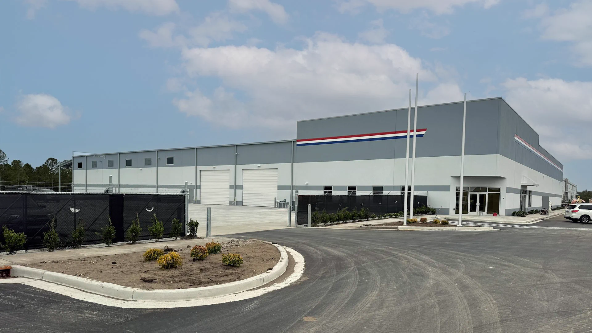 ABC Supply warehouse, office entrance and paved drive on Water Tower Road in Longs, SC.