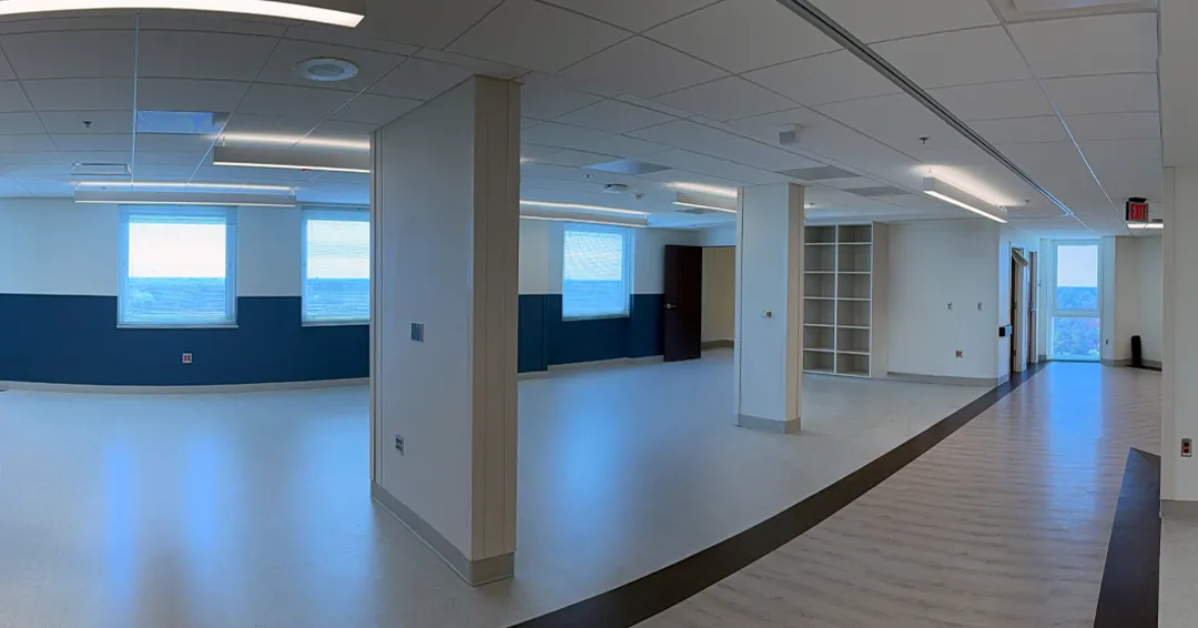 Open interior with columns, blue lower walls and a broad curved walkway at MUSC in Florence.