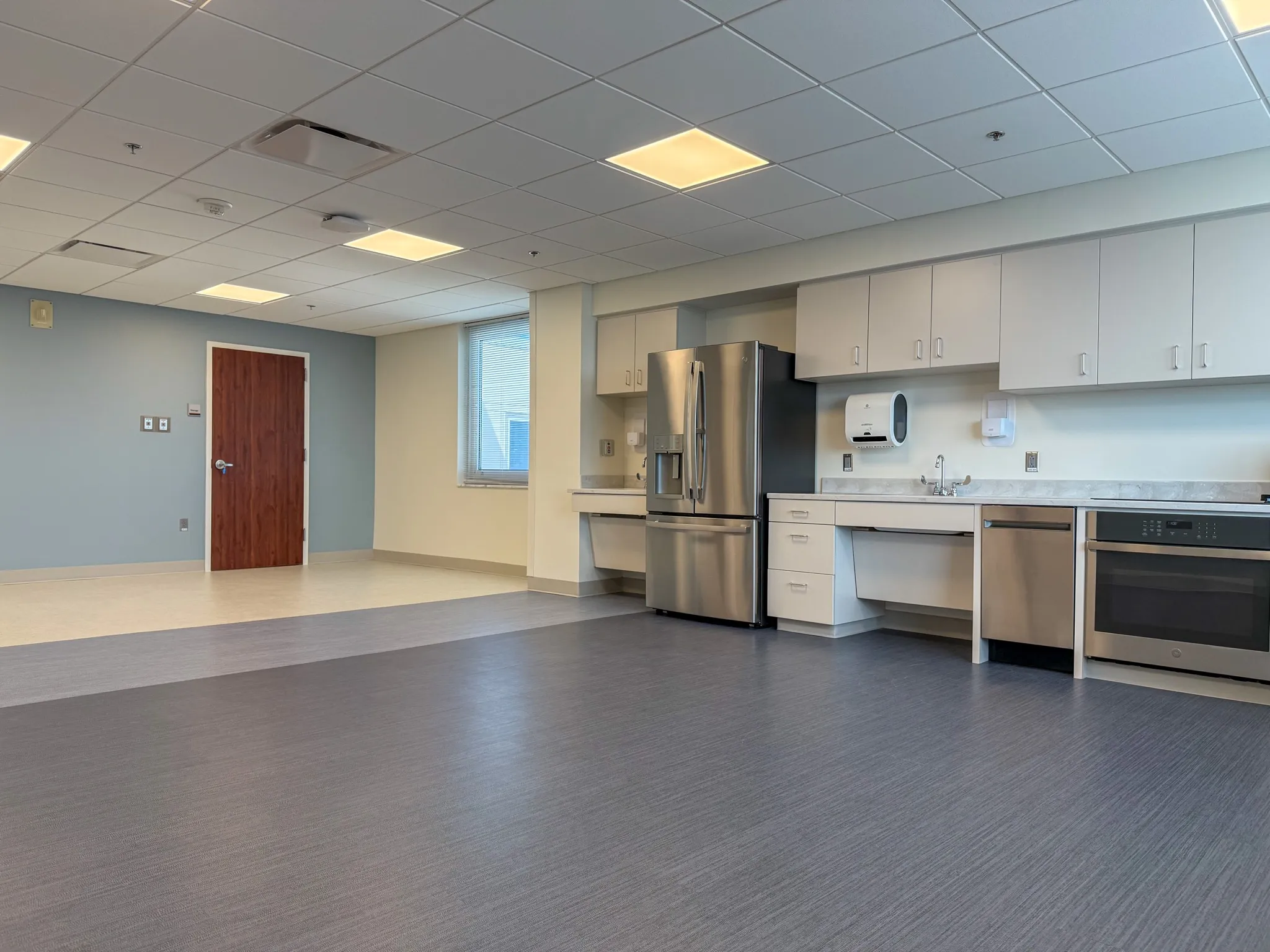 Open floor beside the kitchenette and white cabinets at MUSC in Florence.