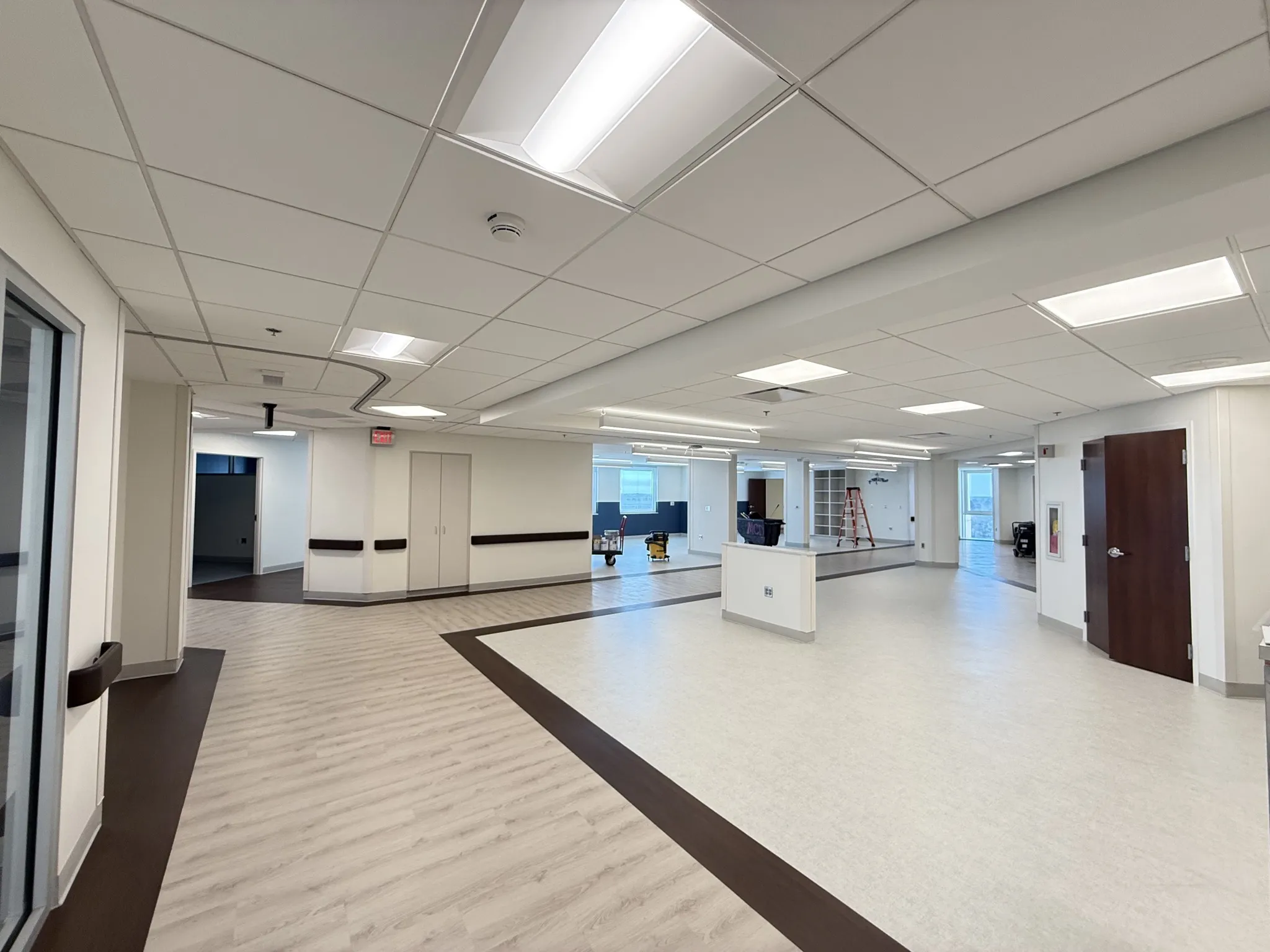 Open MUSC Florence room with a low counter, columns and contrasting floor borders.