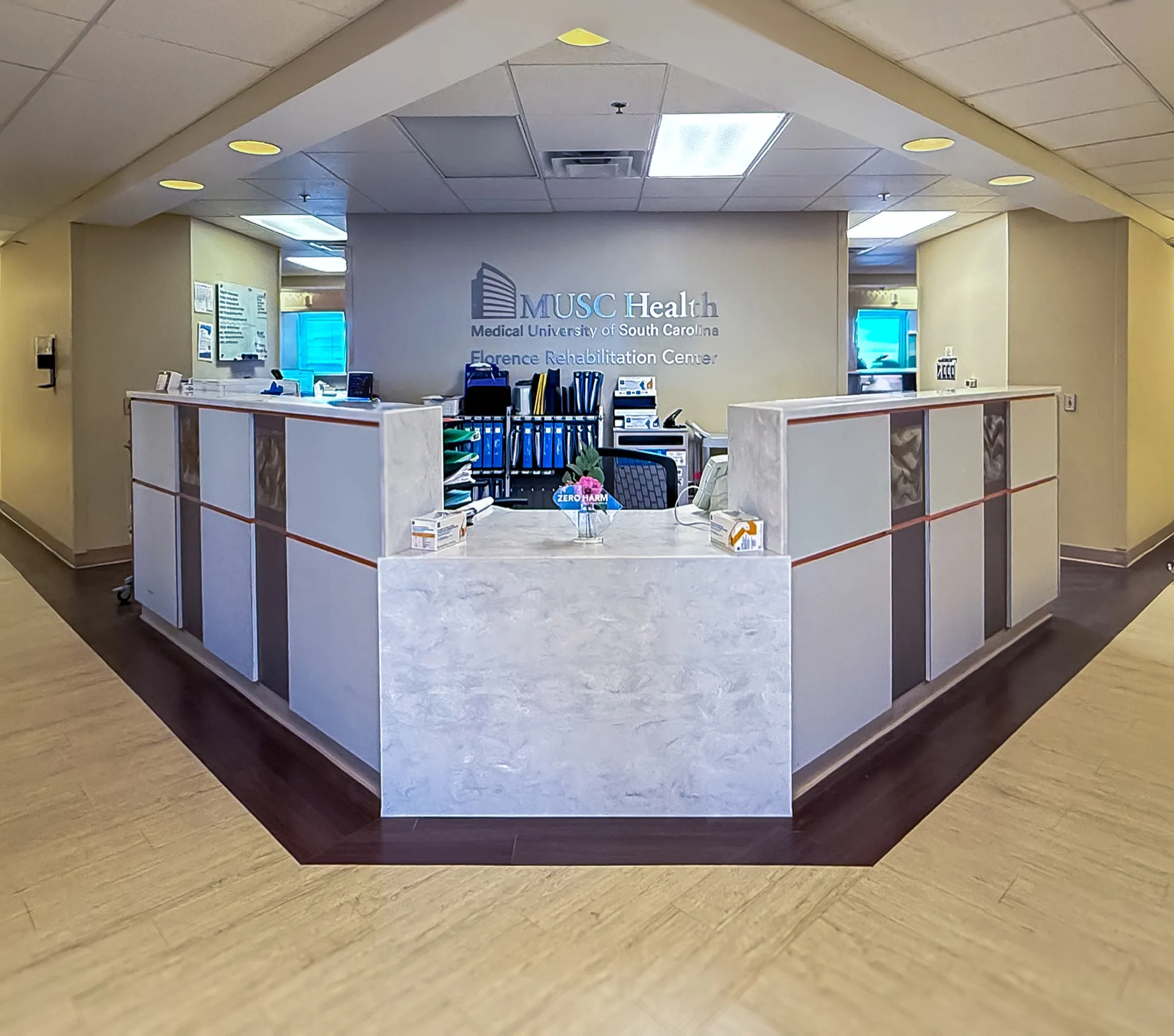 MUSC Florence Rehabilitation Center reception desk beneath a recessed ceiling feature.