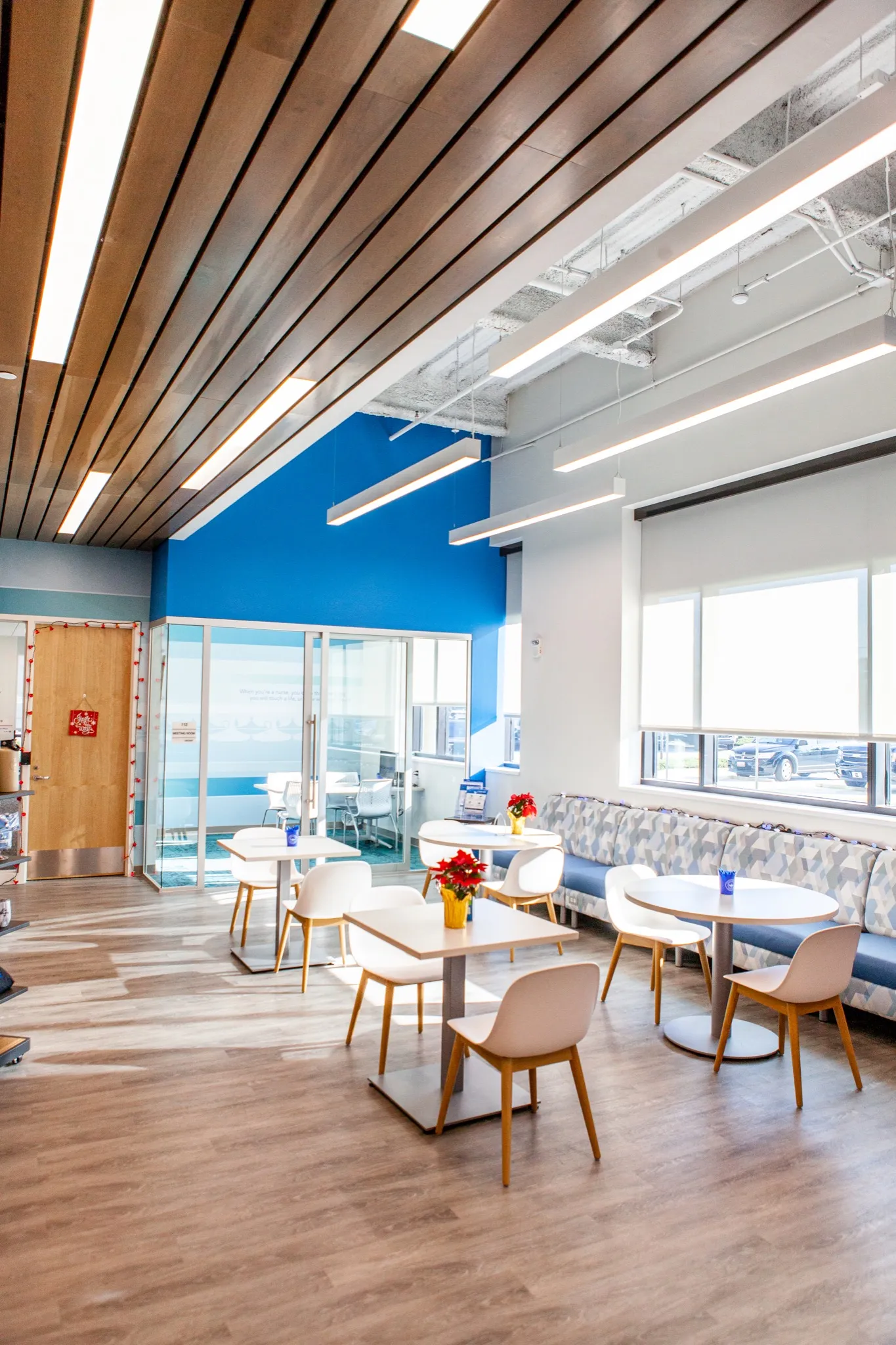 Window-side tables and chairs beneath a slatted ceiling at Galen College of Nursing in Myrtle Beach.