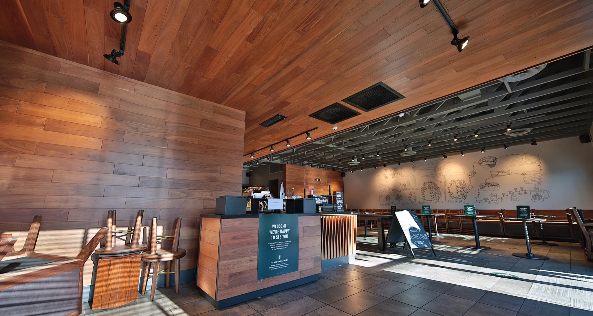 Starbucks Athens interior with wood-toned walls, a service counter and window-side seating.