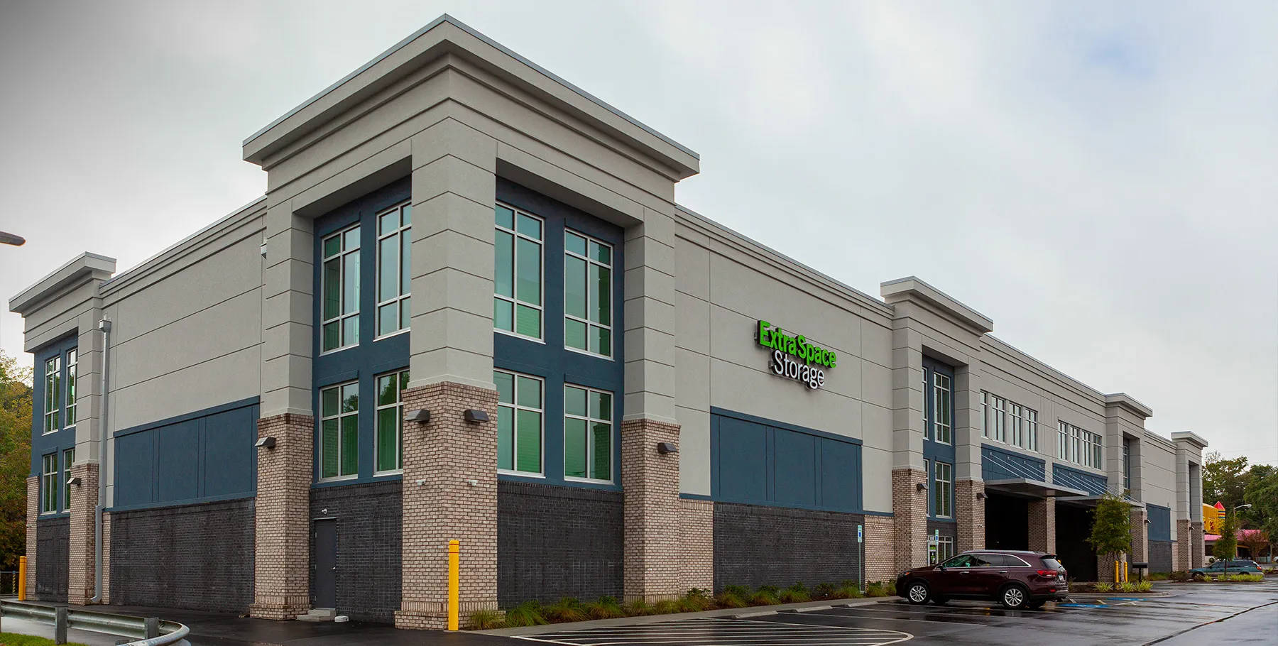 Wide exterior of Extra Space Storage in North Myrtle Beach with corner windows and parking area.