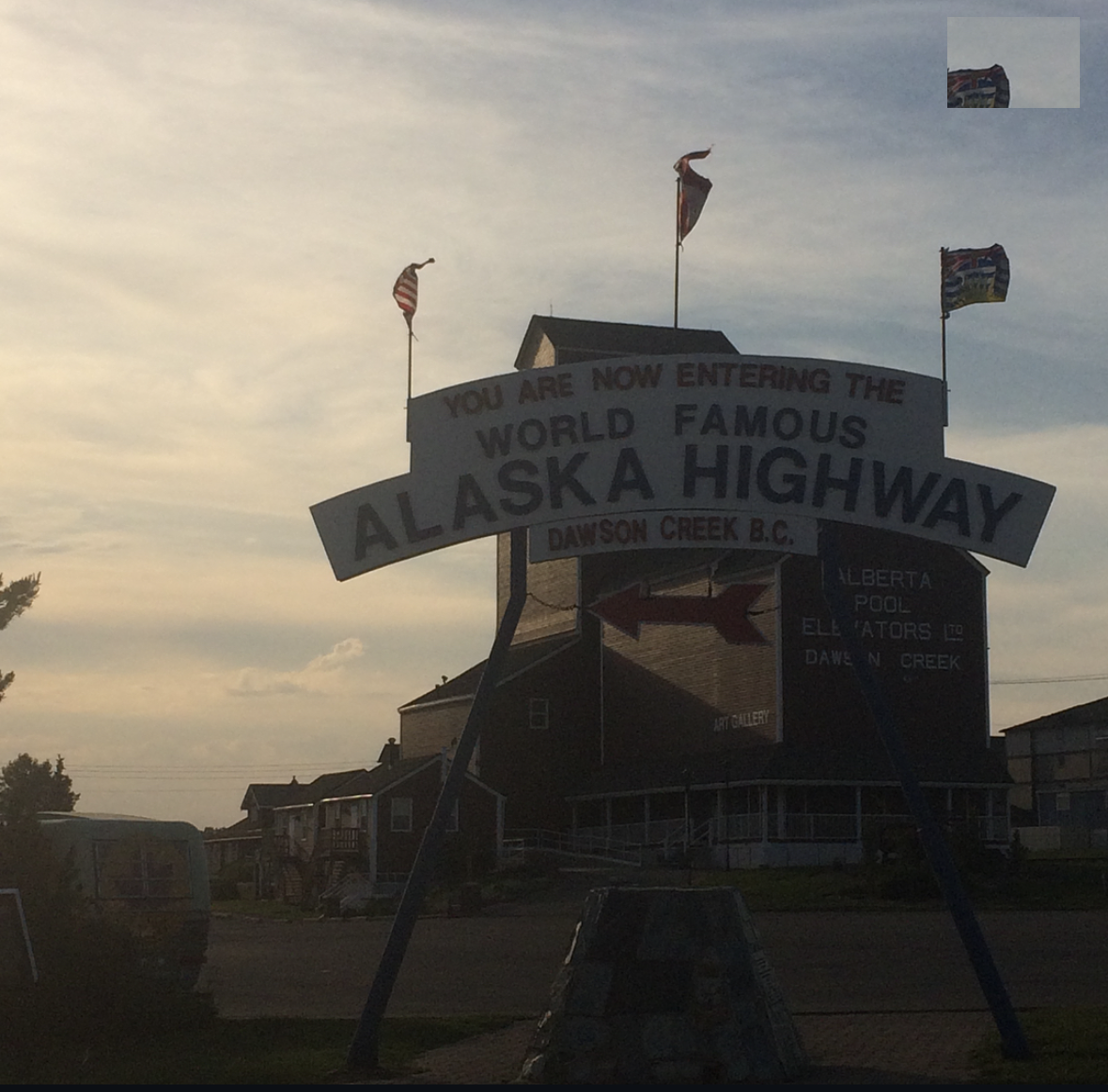 The World Famous Alaska Highway sign at dusk