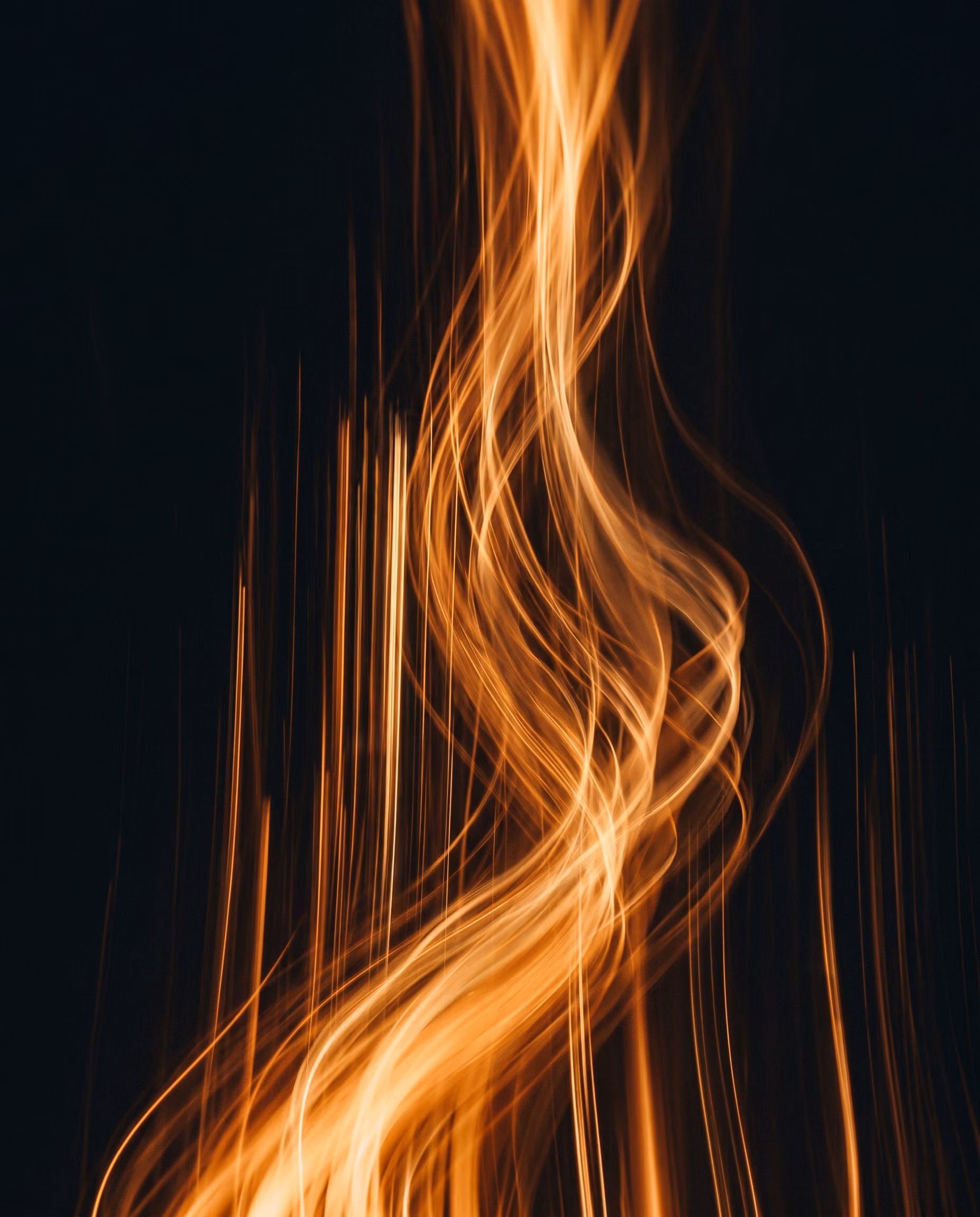 Amber light trails rising through darkness — a new era of motion.