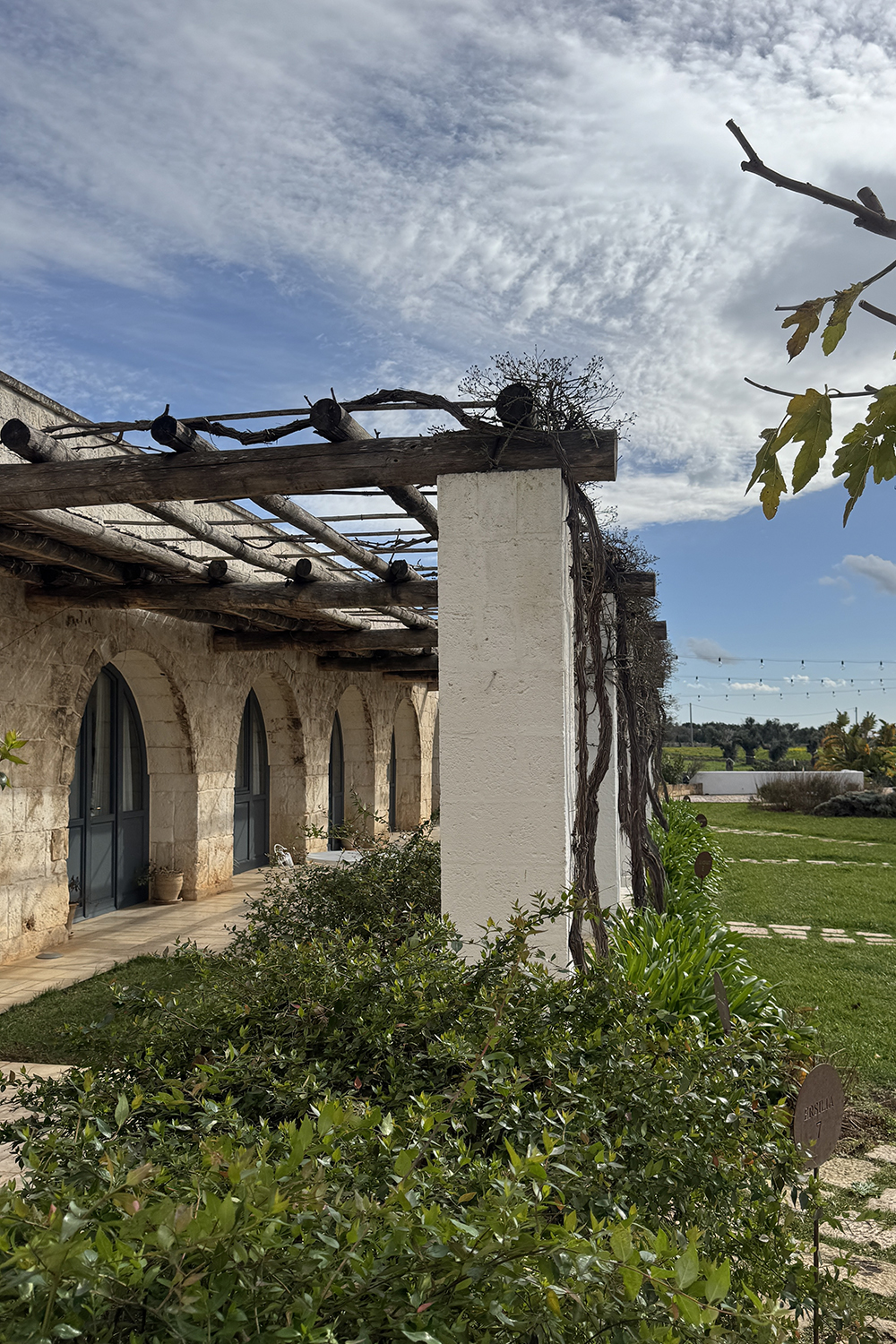 Masseria guestroom terrace with pergola and Mediterranean garden in Puglia