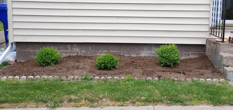 Mulch application and garden clean-up project completed by Diamond Landscape & Design.
