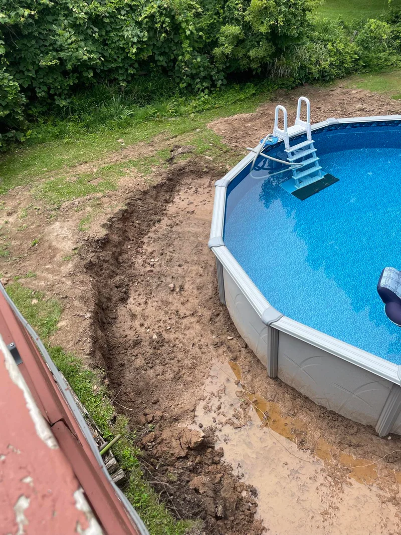 Wooden retaining wall built around above-ground pool.