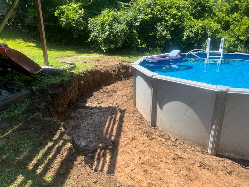 Wooden retaining wall built around above-ground pool.