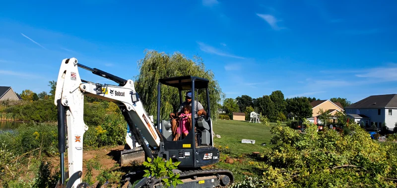 Clearing of riverside terrain with an excavator.