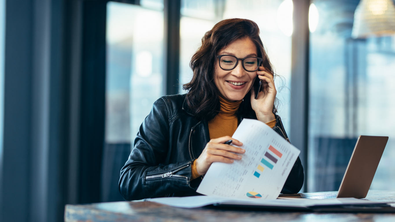 Founder on a phone with laptop