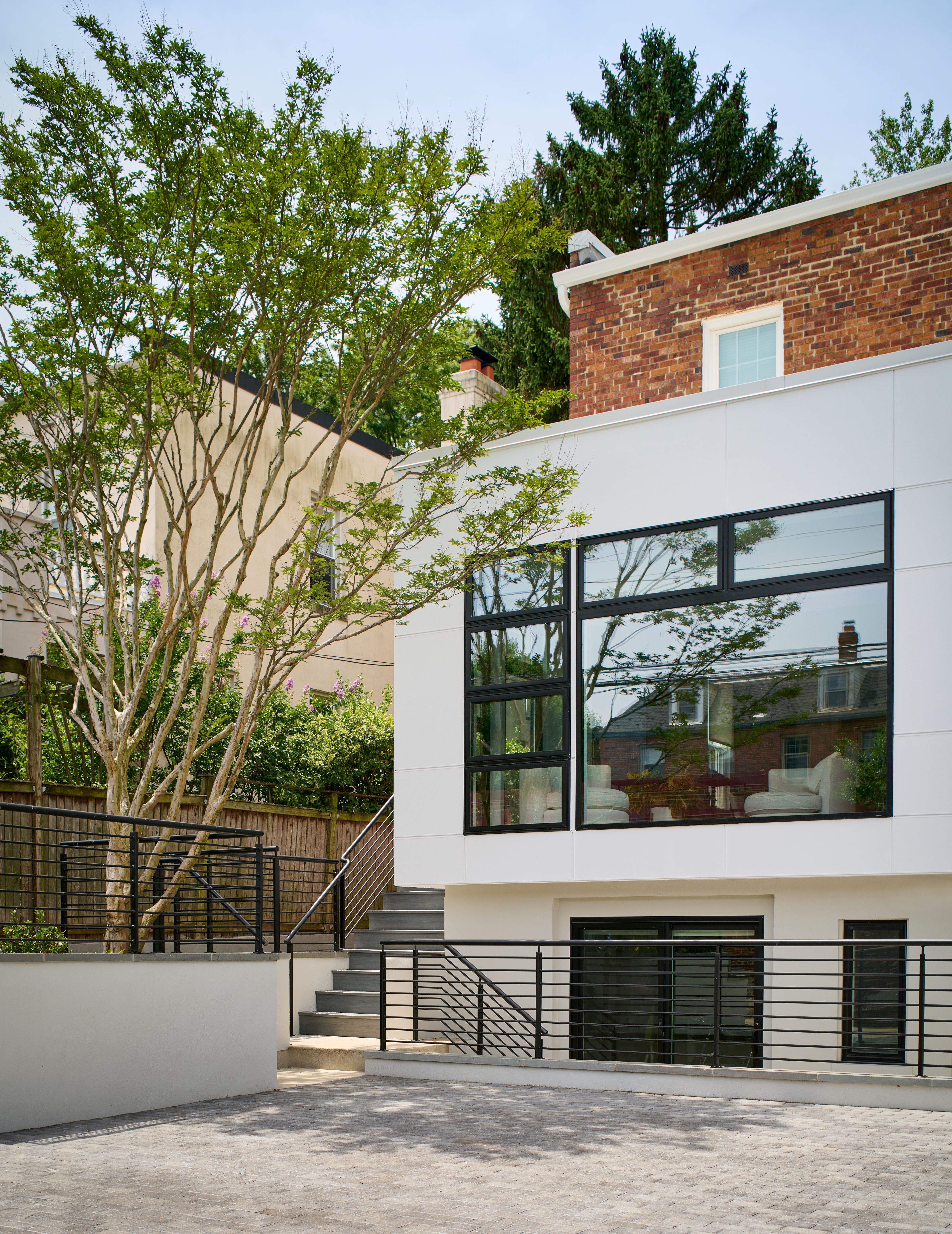 Elegant home addition with architectural details viewed from rear yard
