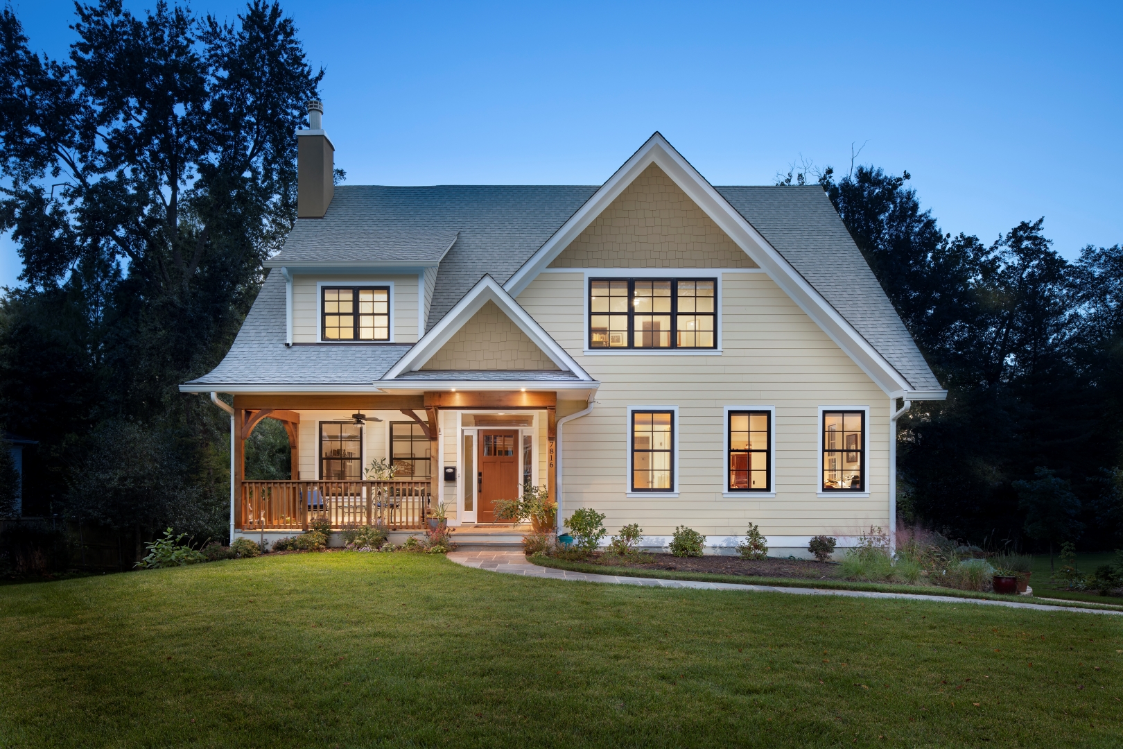 Aberdeen custom home exterior with night lighting enhancing architectural features