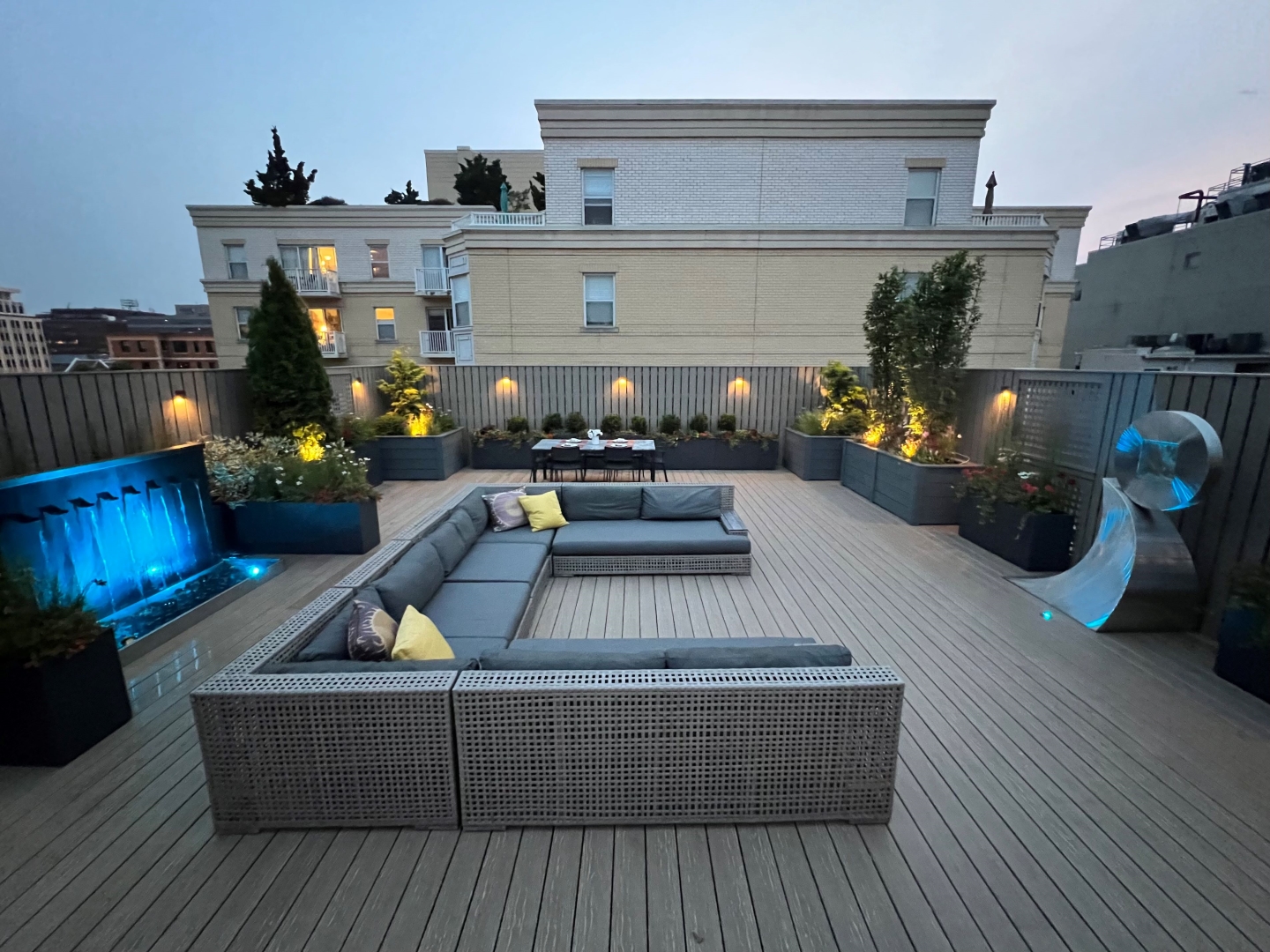 Roof deck at twilight featuring premium outdoor furniture and lighting design