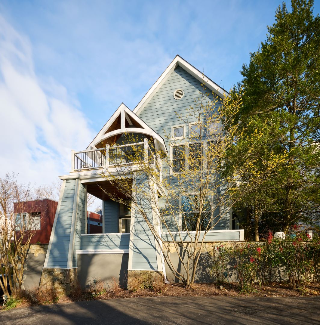 Side view of home's exterior showcasing new siding, trim, and landscaping elements