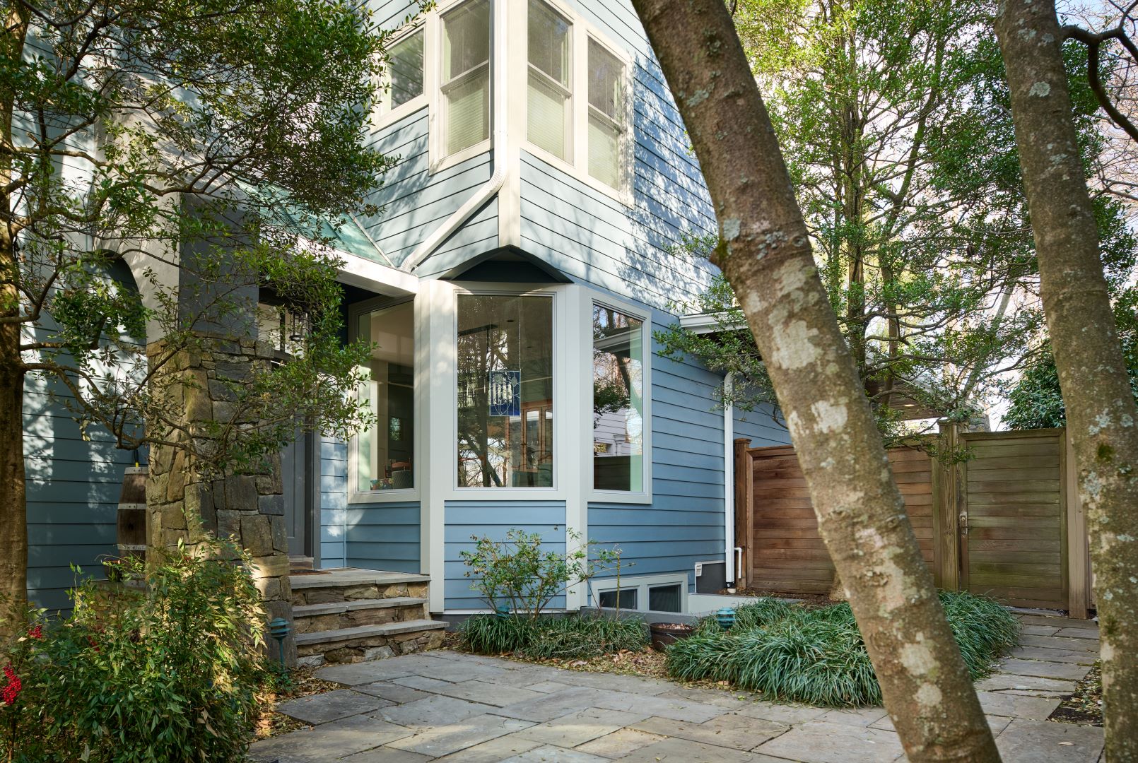 Exterior view showing replaced siding and trim with weather-resistant materials to prevent moisture issues