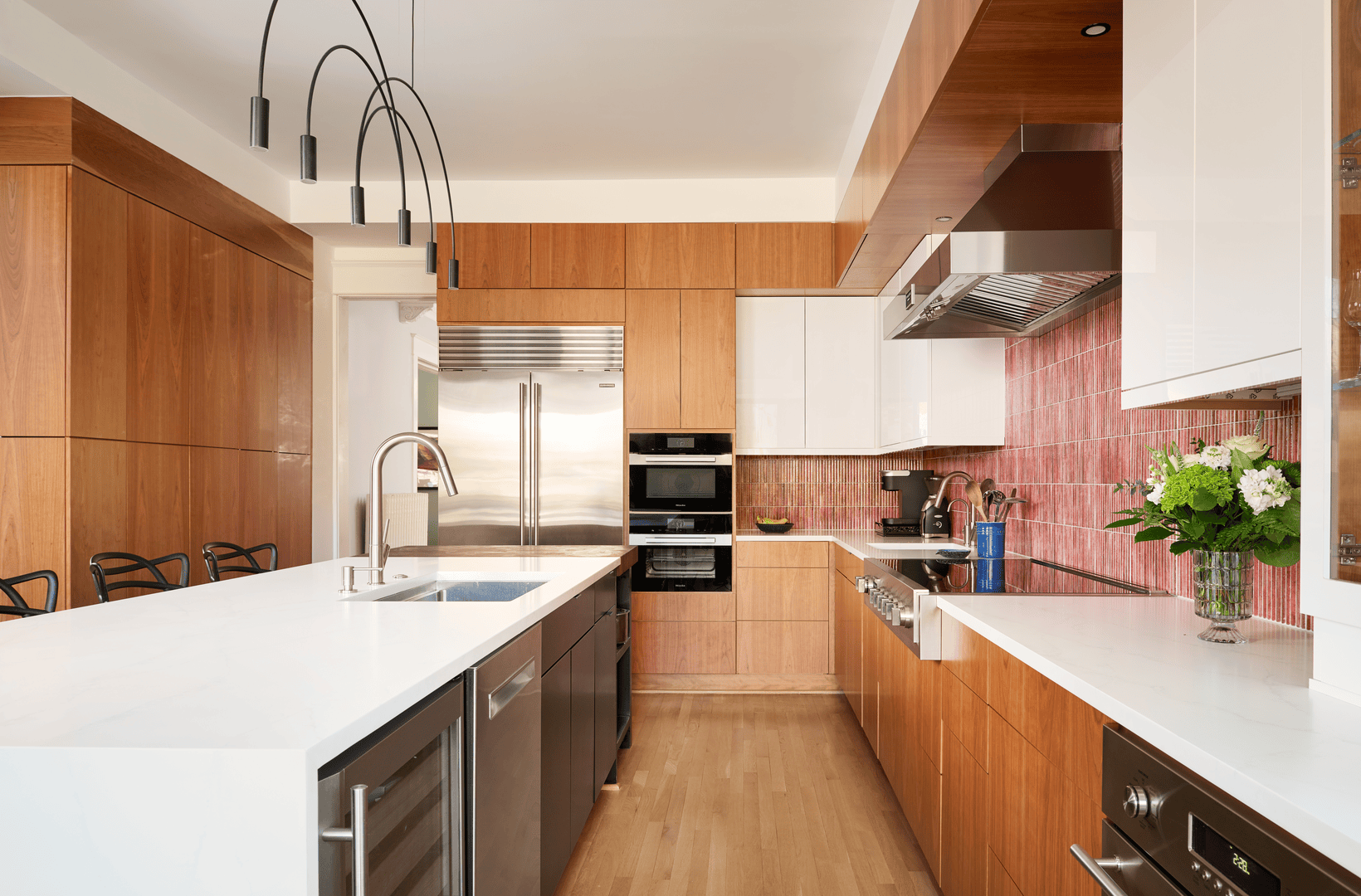 Elegant kitchen island with pendant lighting and seating area in renovated Cleveland Park home