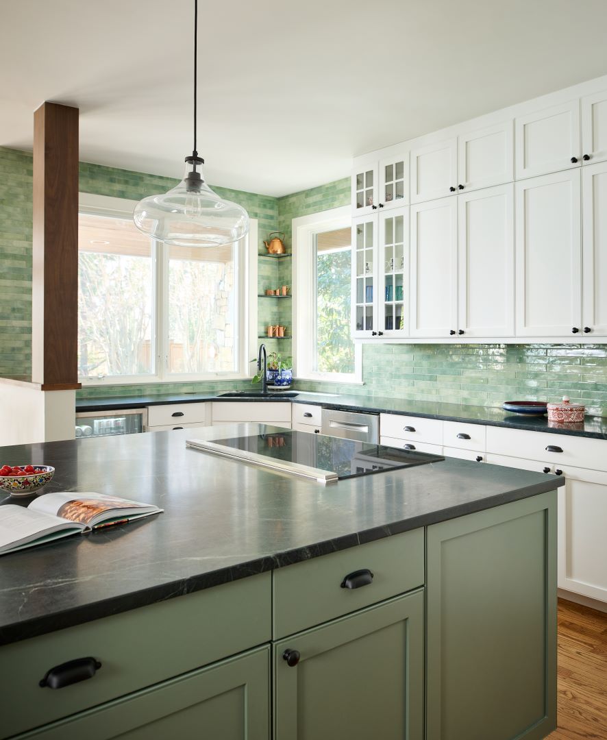 Close view of kitchen island with induction cooktop and thoughtful storage solutions