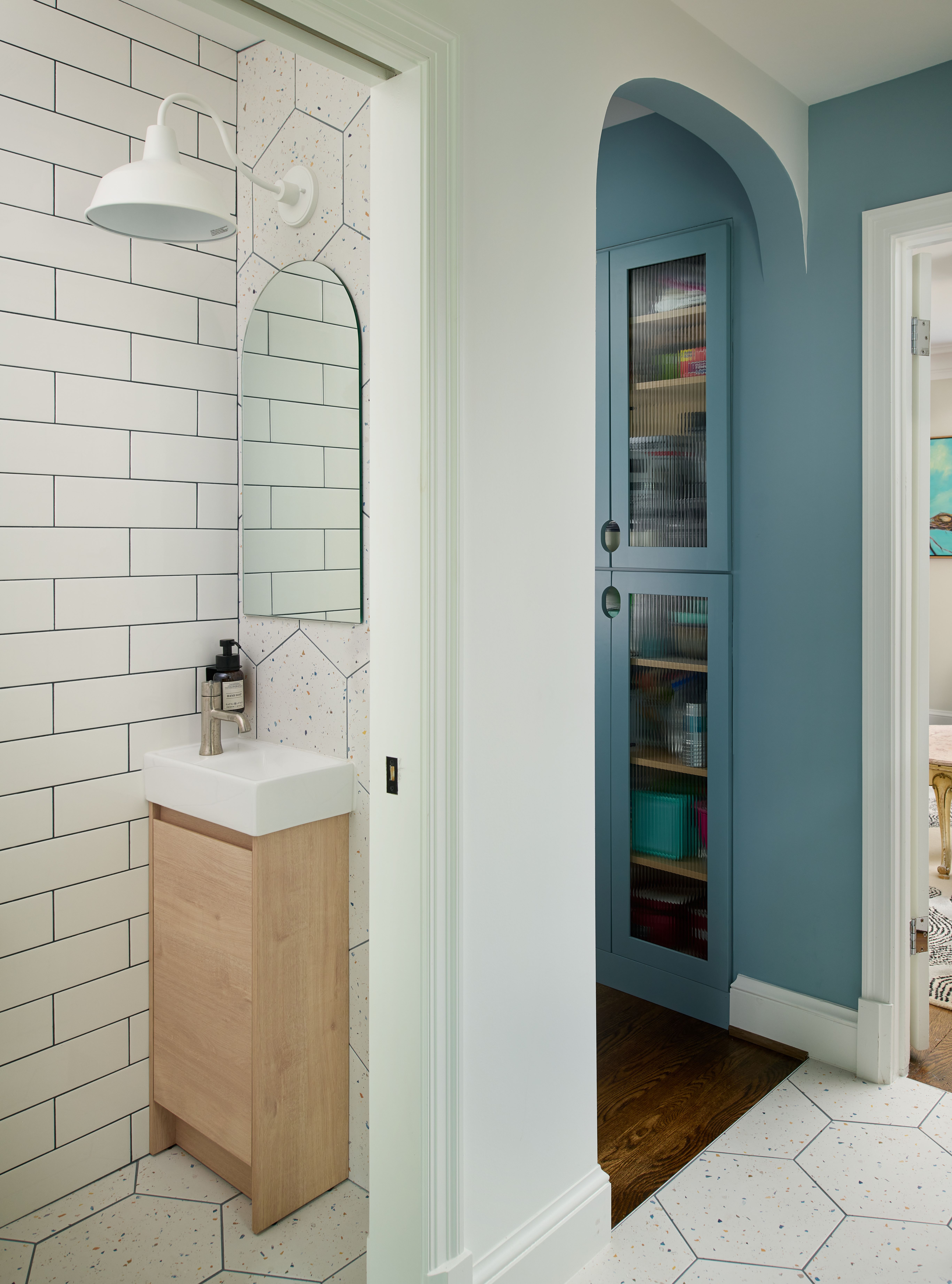 Stylish powder room with wall-mounted sink, premium fixtures, and carefully curated design elements in calming blue tones