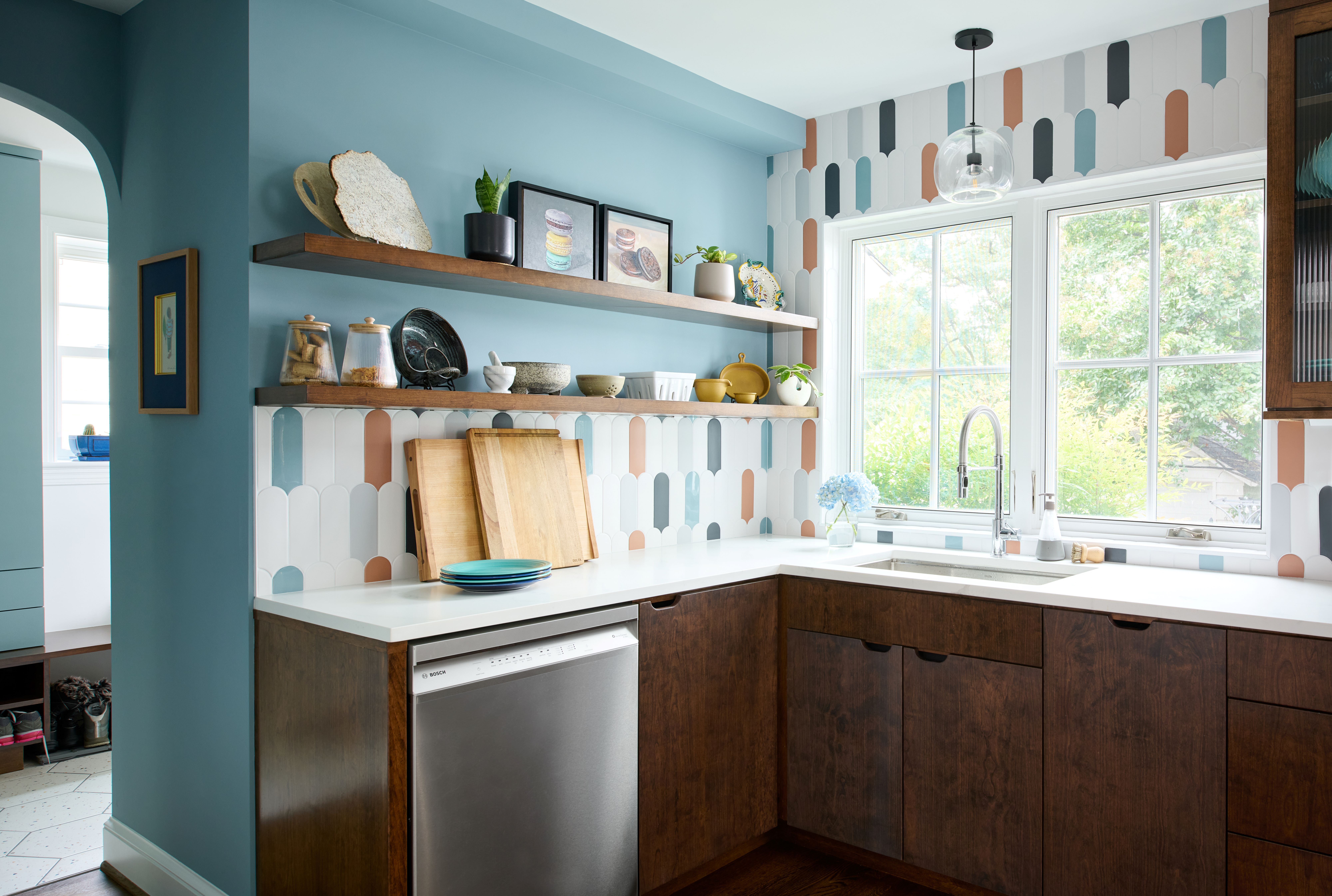 Detailed view of kitchen showing tile backsplash pattern and modern fixture selections