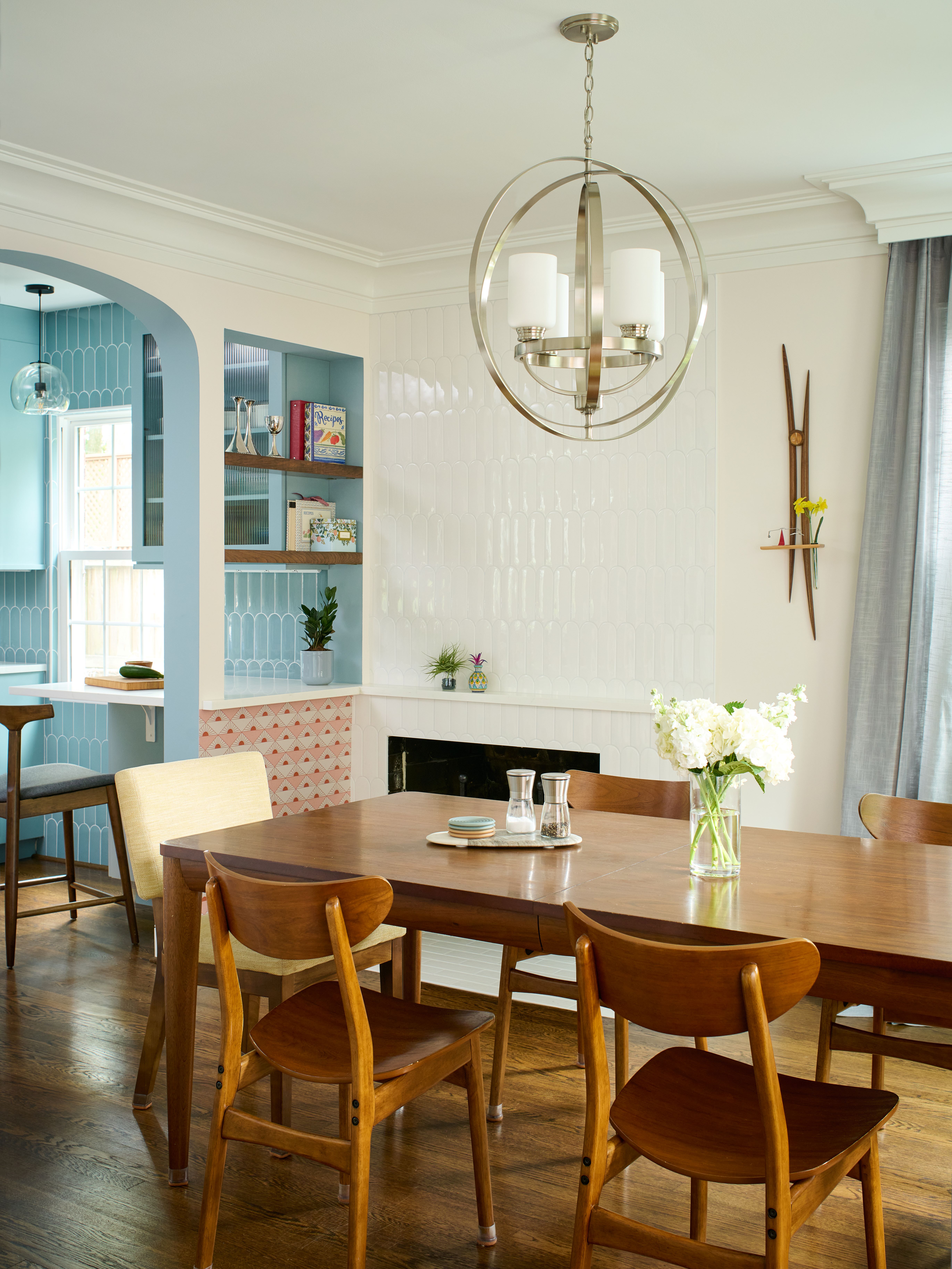 Kitchen entry view showcasing blue cabinetry, white countertops, and open shelf storage design