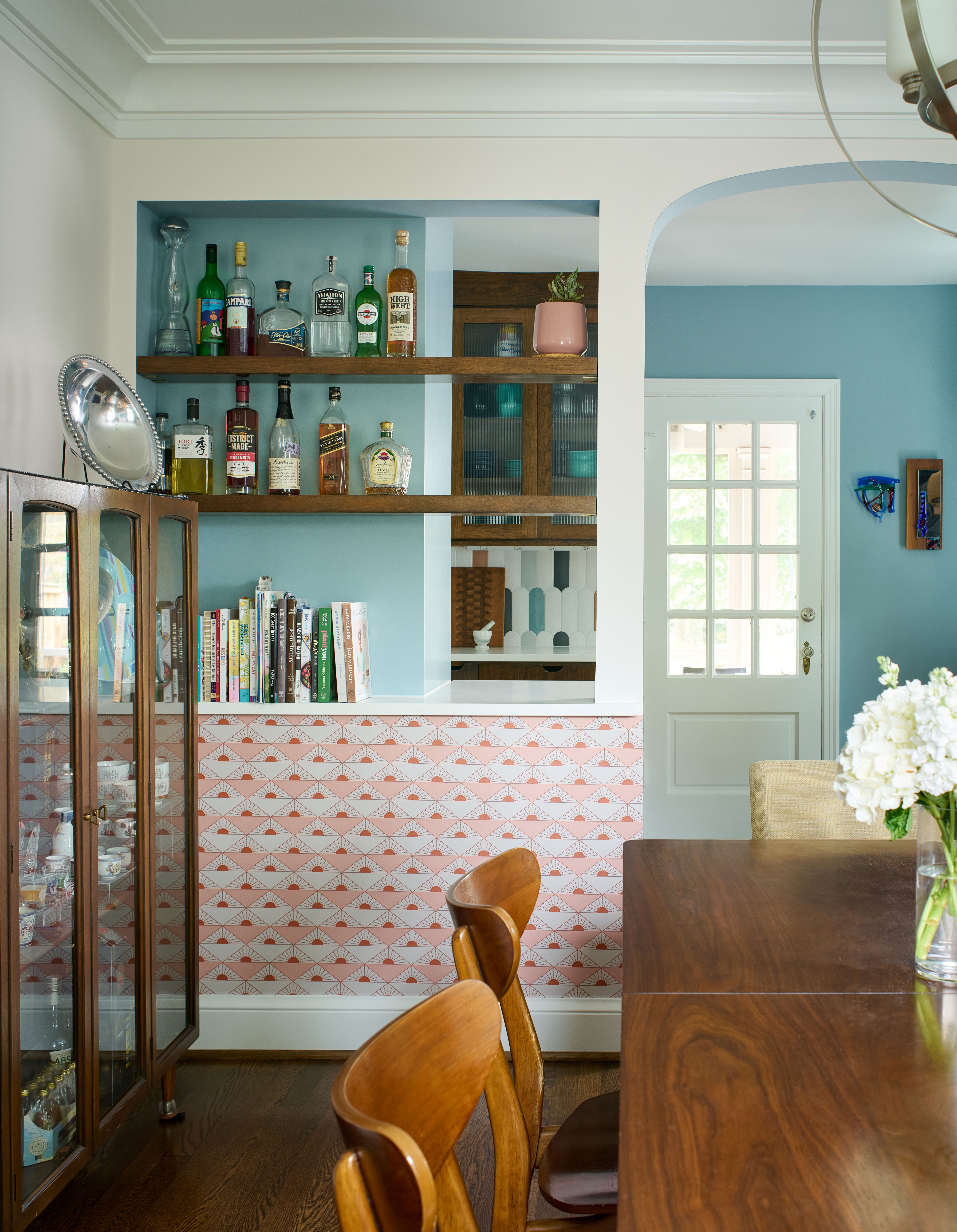 Dining area connected to kitchen featuring stylish table setting and natural light from windows