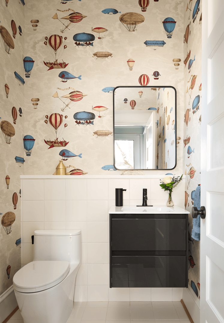 Designer powder room with eye-catching wallpaper, contemporary fixtures, and refined finishes