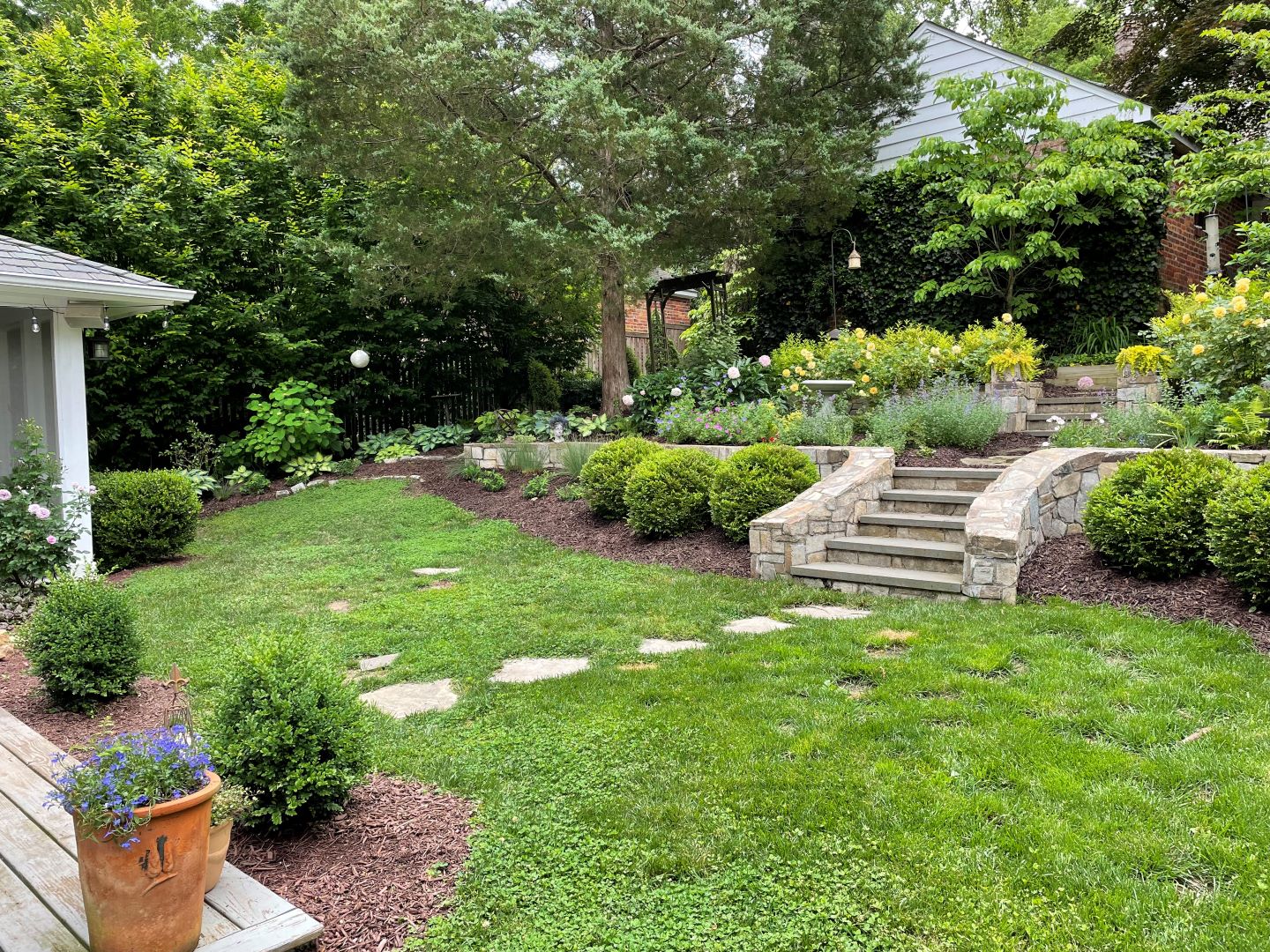 Lush hillside planting design showcasing careful plant selection for slope stabilization