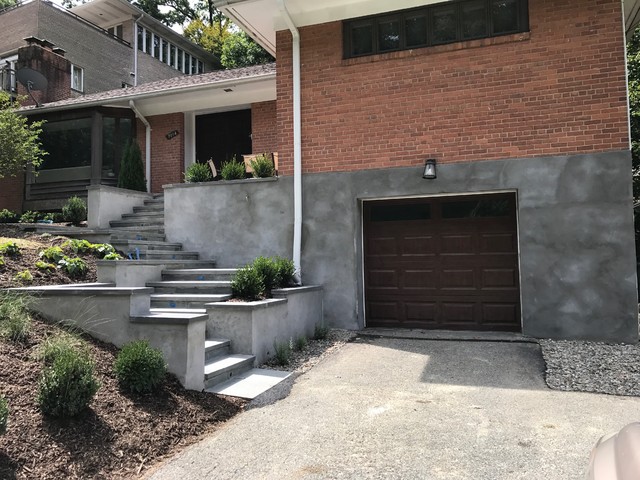 Side view of modern entrance showing integrated steps, landing area, and architectural lines