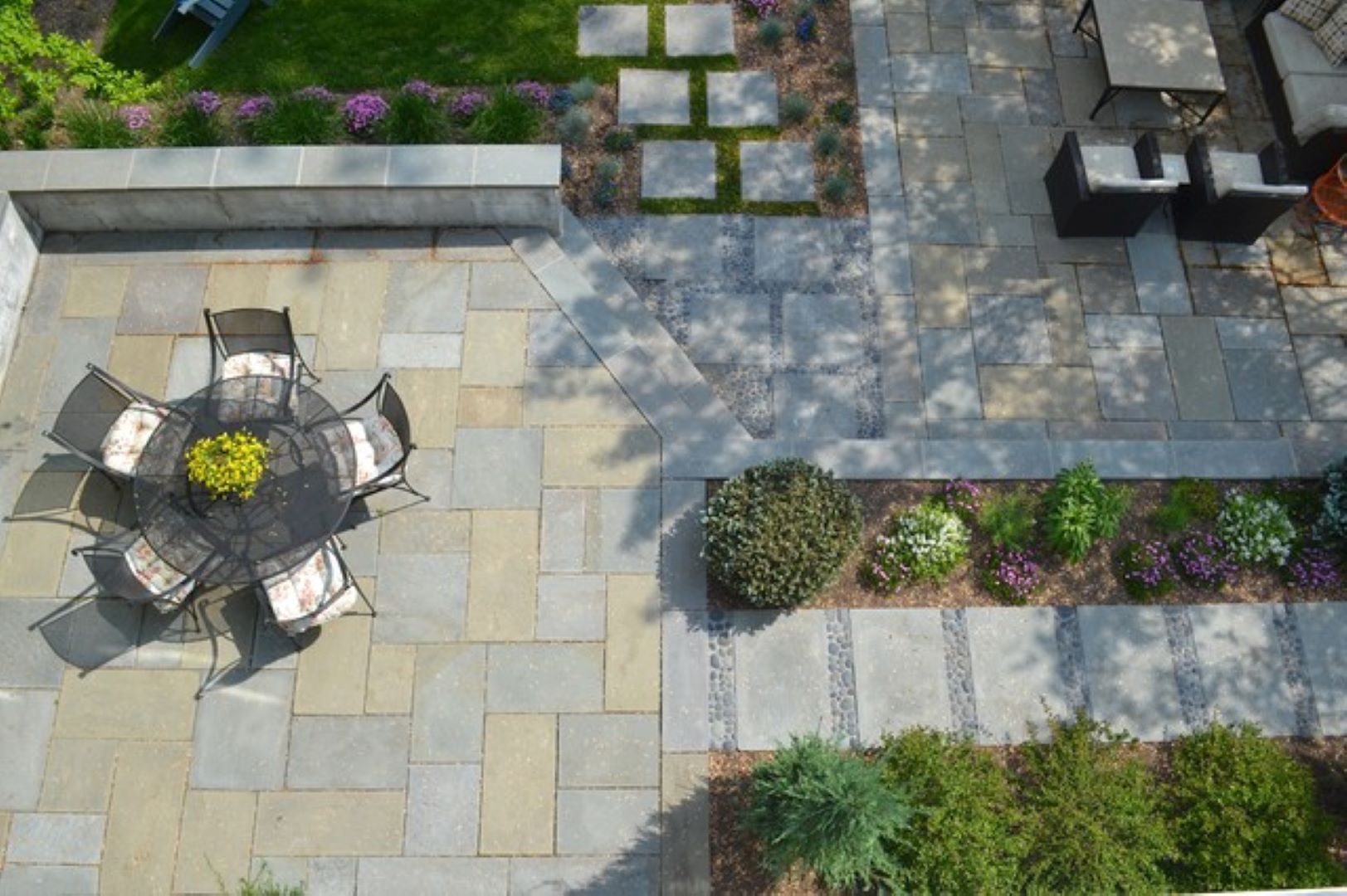 Two-level flagstone patio with contemporary design featuring geometric patterns and integrated outdoor living areas