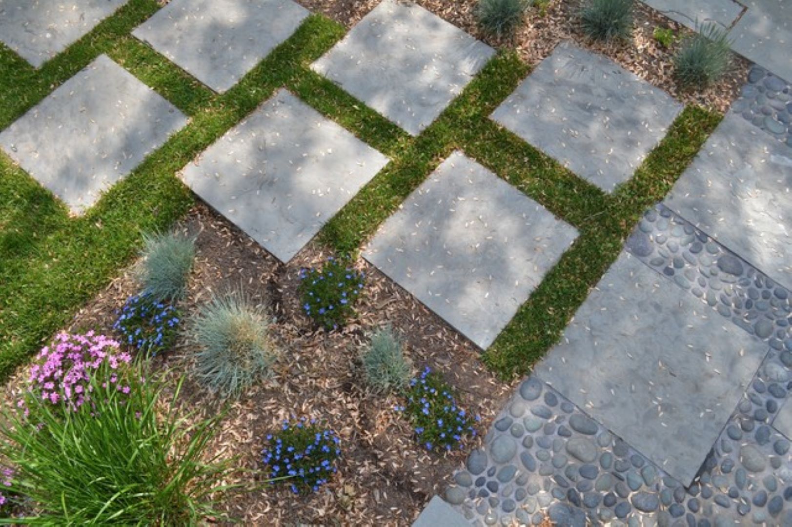 Detail view of mexican pebble landing areas integrated with rectangular flagstone pattern