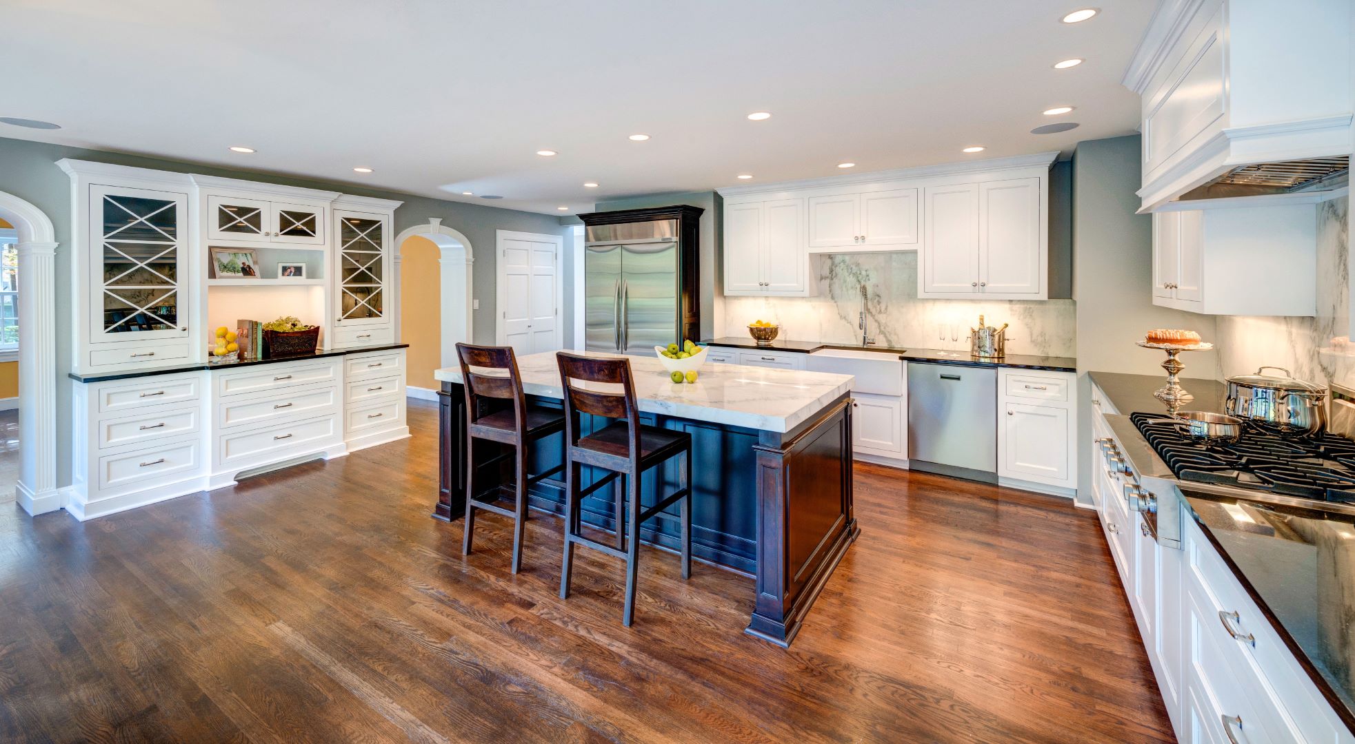 Kitchen island with pendant lighting and stone countertop providing central workspace