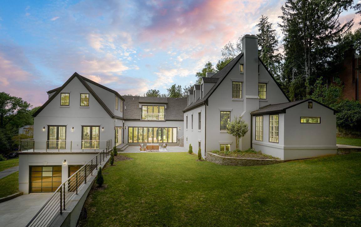 Evening view of Cape Cod modern transformation highlighting architectural lighting and indoor-outdoor connection