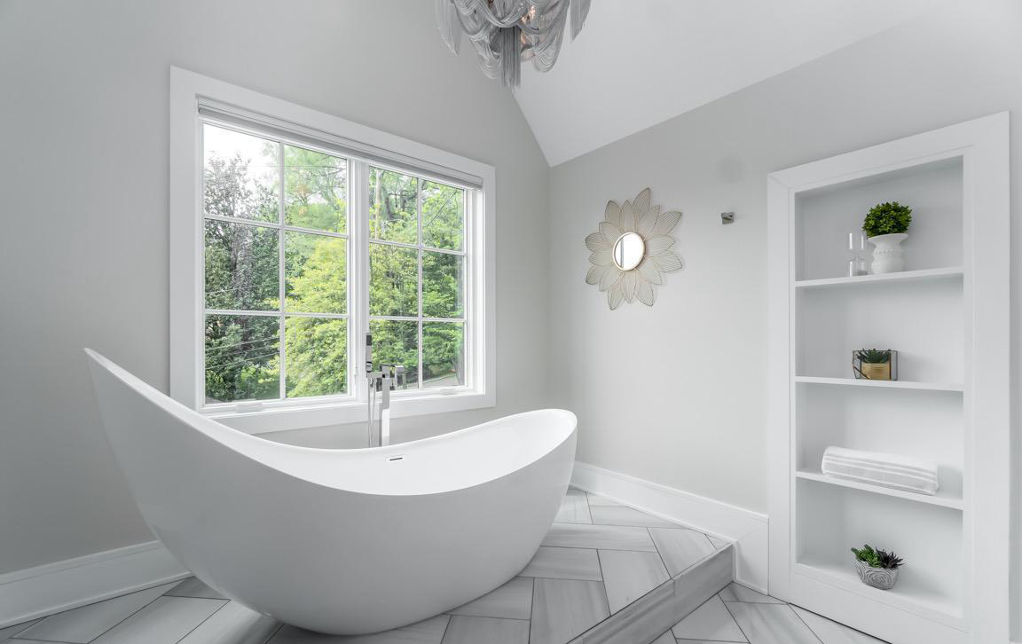 Contemporary bathroom featuring floating vanity, minimalist fixtures, and sleek tile design in modernized Cape Cod home