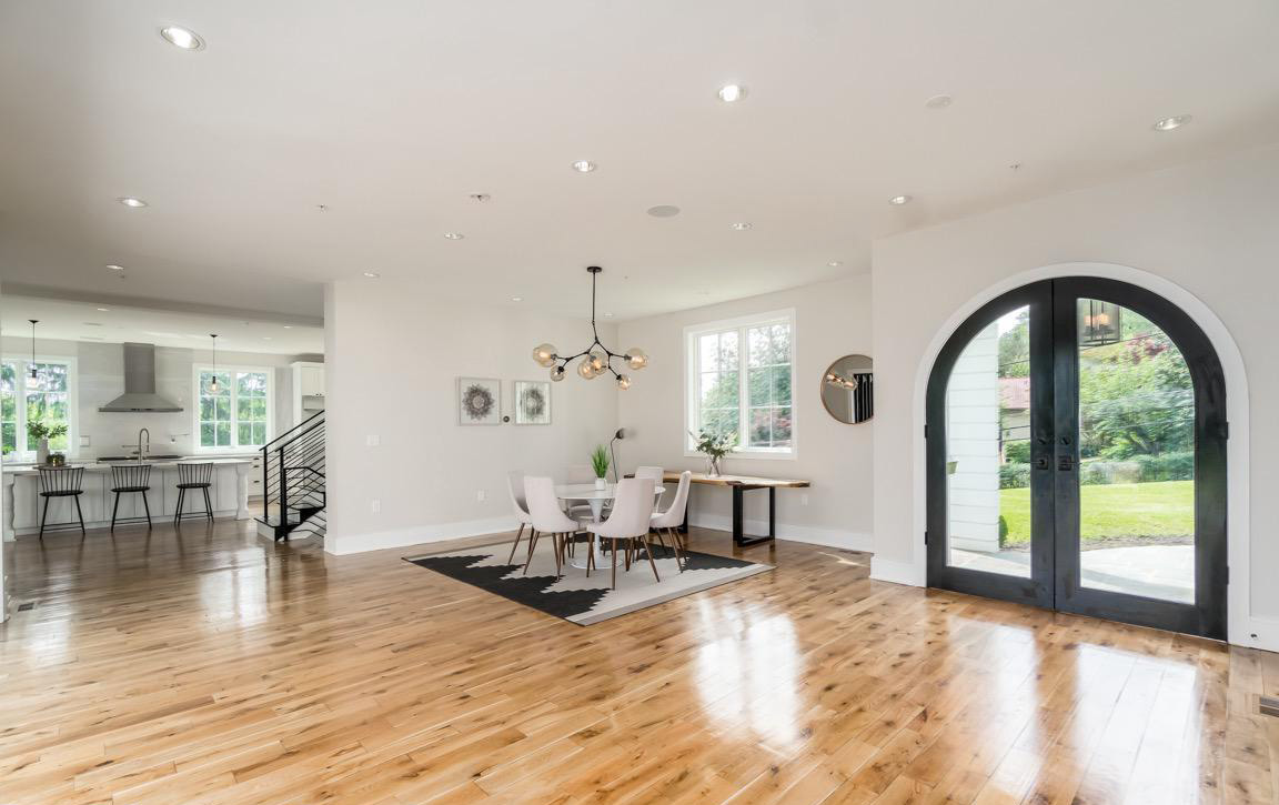 Open floor plan showcasing seamless connection between kitchen, dining, and living areas with contemporary design