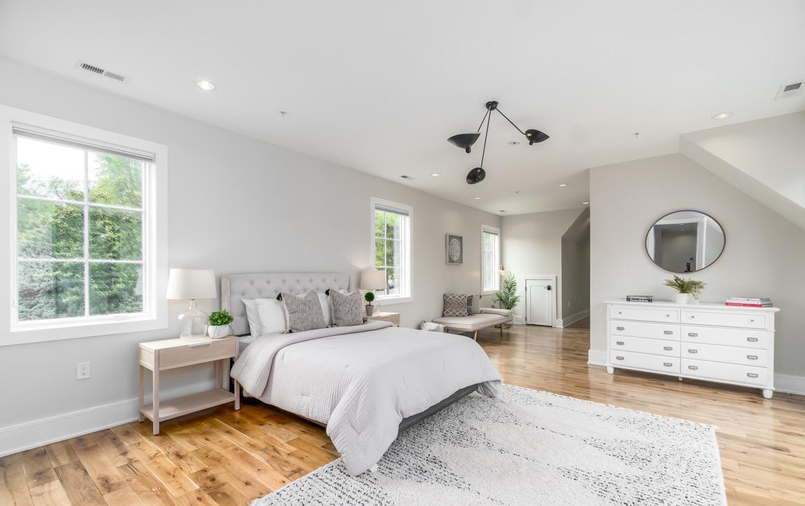 Bedroom featuring minimalist design, built-in storage, and abundant natural light