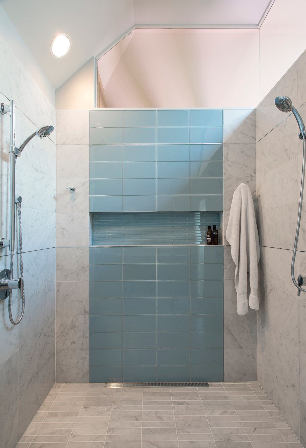 View of bathroom showcasing how attic space was maximized to create a spacious, light-filled retreat
